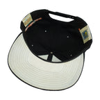 Interior and white underbrim view of the black and white Baltimore Orioles bird-logo snapback cap