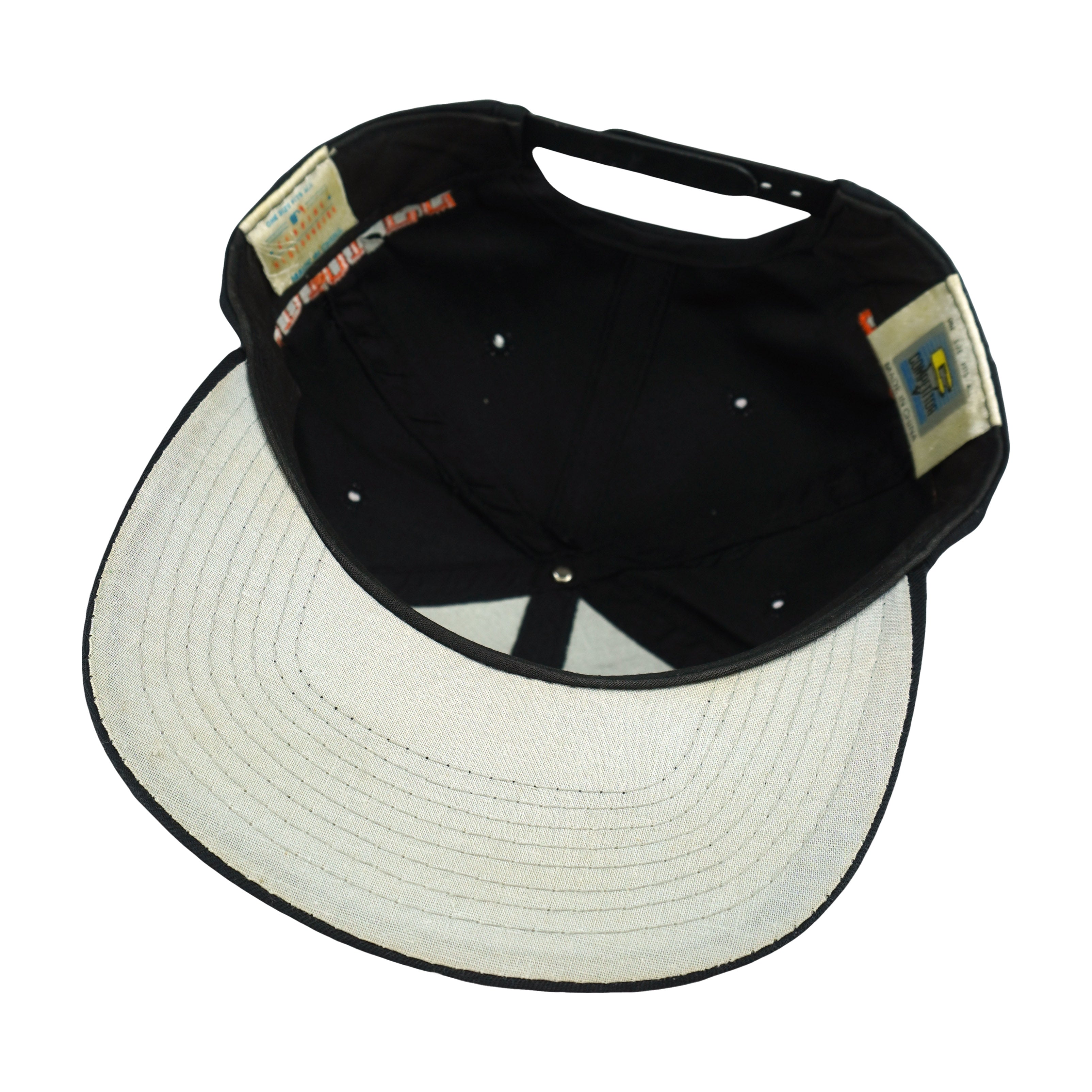 Interior and white underbrim view of the black and white Baltimore Orioles bird-logo snapback cap