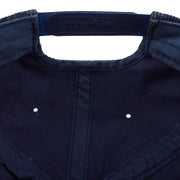 Close view of the Yupoong embossing on the navy snap closure
