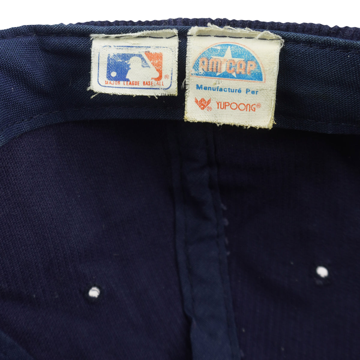 MLB label beside the AMPCAP label identifying Yupoong as the cap manufacturer