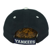 Rear of the dark New York Yankees cap with white eyelets and an embroidered strap