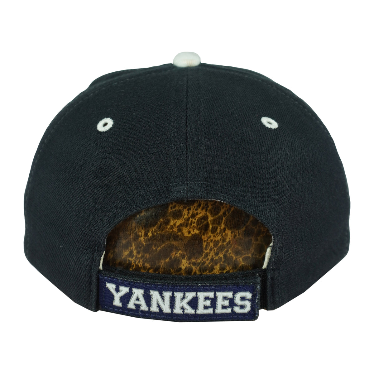 Rear of the dark New York Yankees cap with white eyelets and an embroidered strap