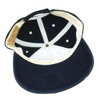 Interior of the dark New York Yankees cap with a white sweatband and navy brim underside