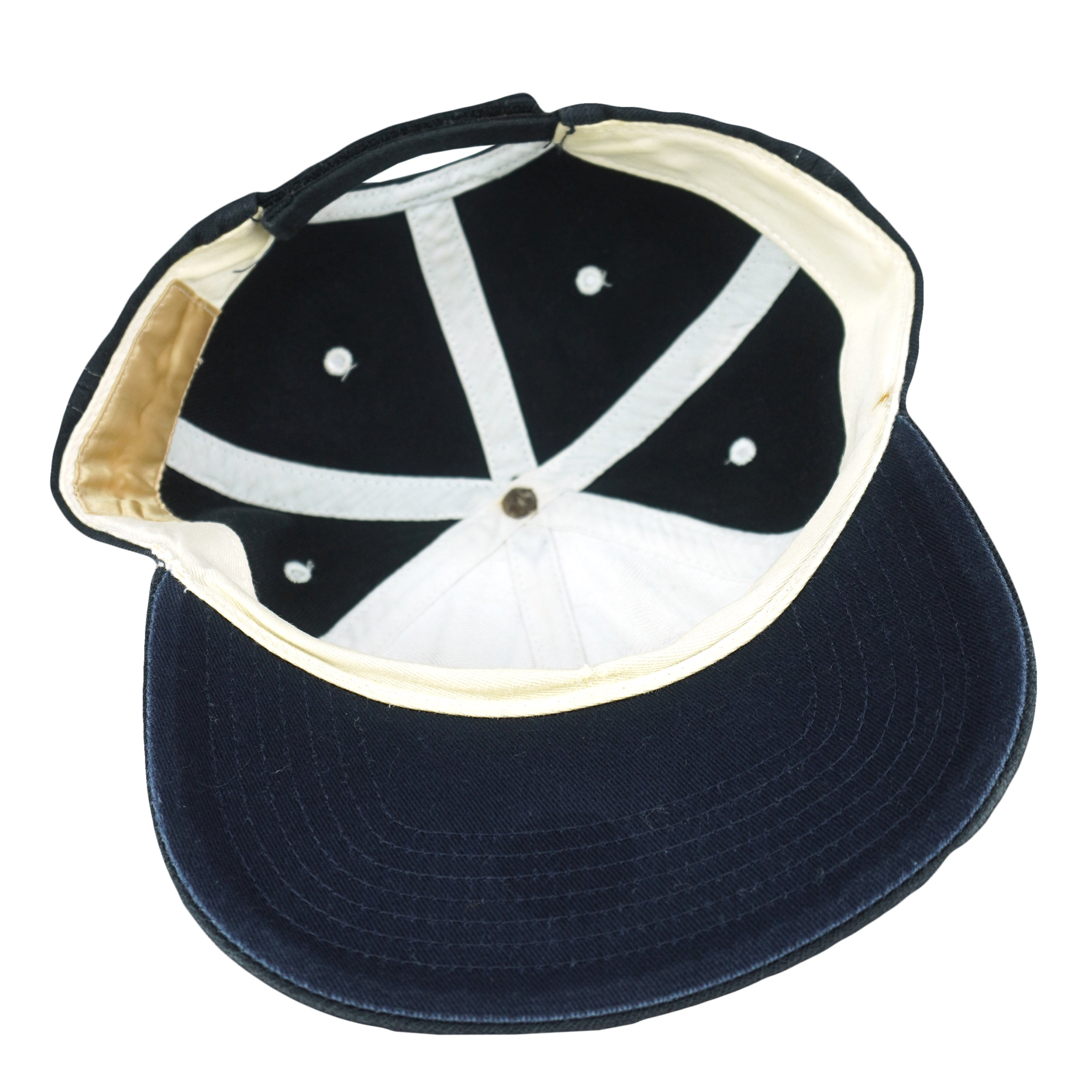 Interior of the dark New York Yankees cap with a white sweatband and navy brim underside