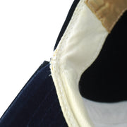 Close view of the Yankees cap interior rear seam with fraying along the sweatband
