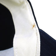 Small brown mark along the white inner sweatband of the dark New York Yankees cap