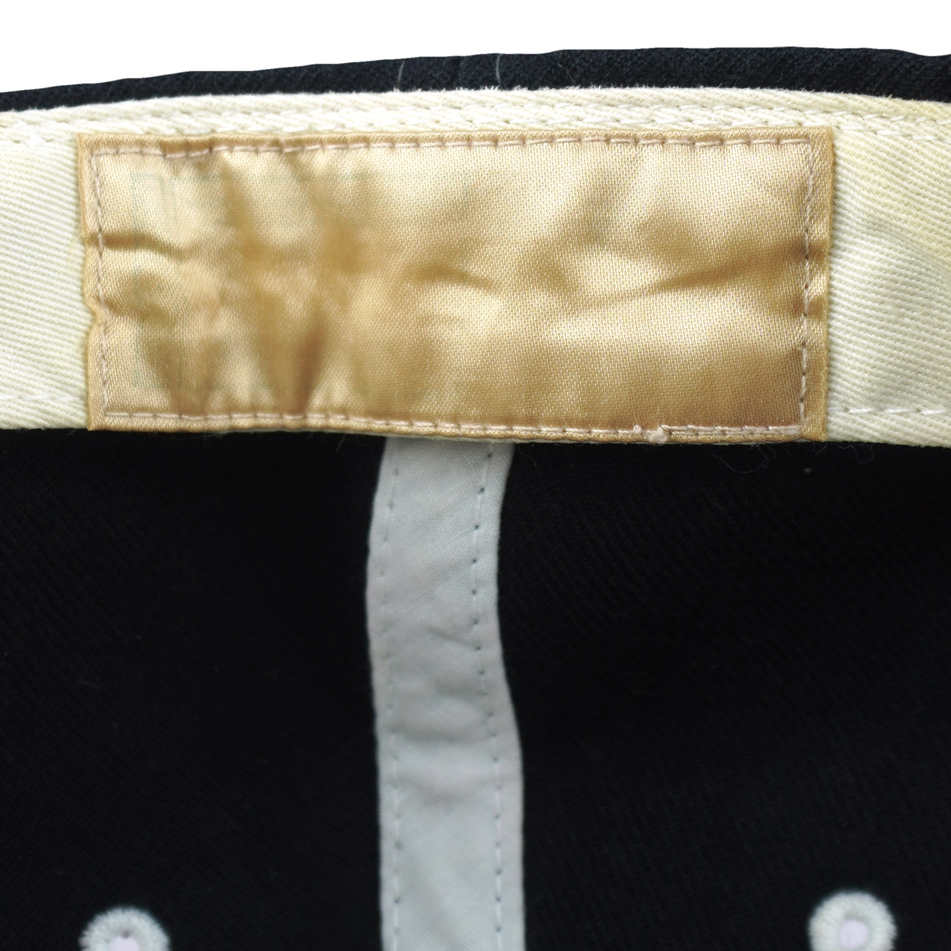 Close-up of the faded blank inner sweatband label on the New York Yankees hat
