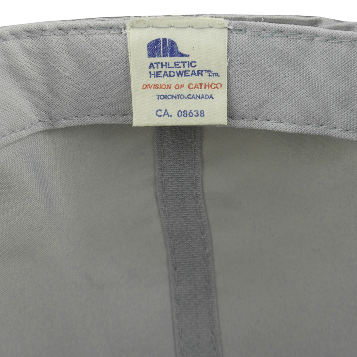 Close-up of the Athletic Headwear label sewn inside the gray Canada's Grain Train hat
