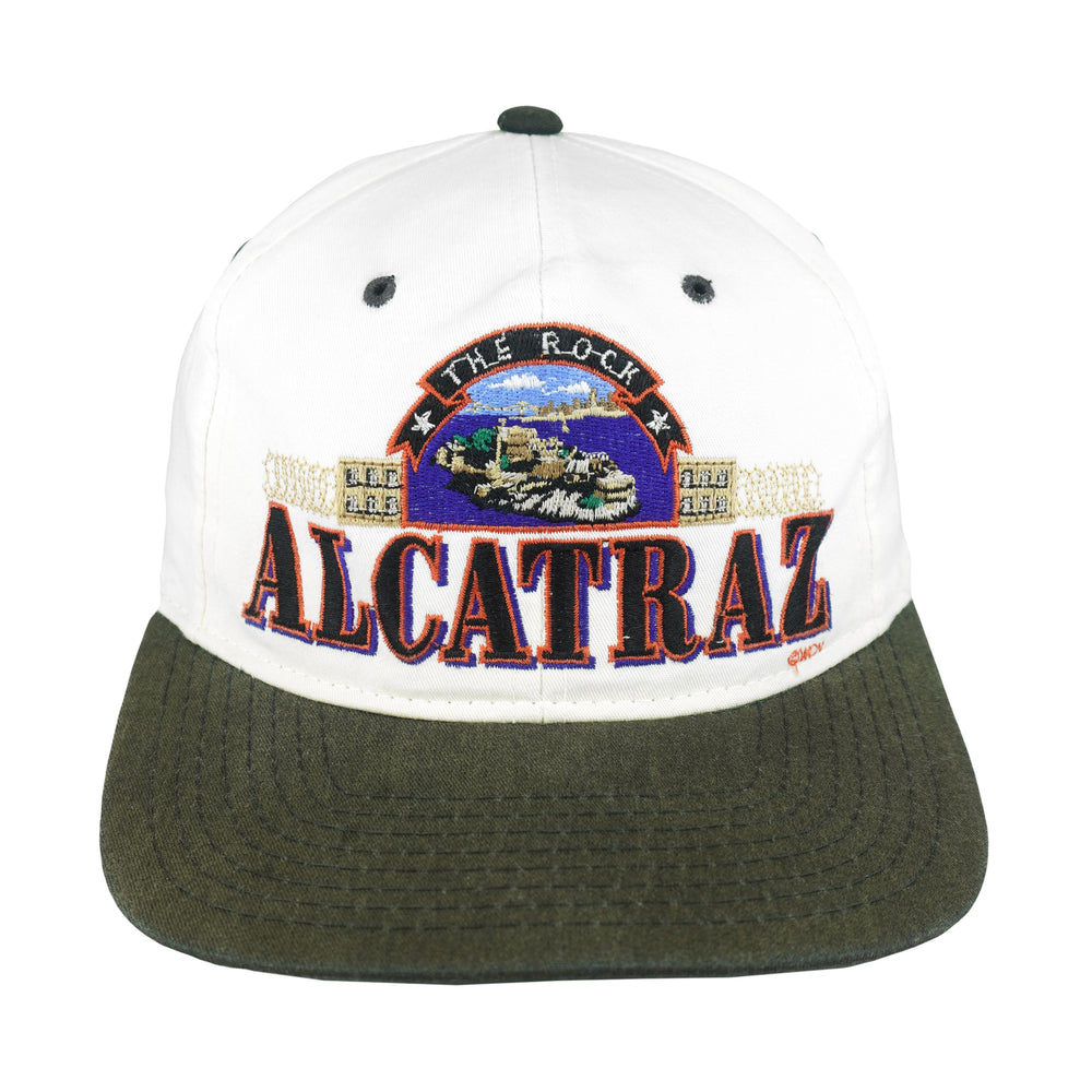 Front view of the white, black, and green 1990s The Rock Alcatraz scenic snapback hat