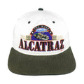 Front view of the white, black, and green 1990s The Rock Alcatraz scenic snapback hat