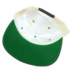 Maker and size label close-up of the white, black, and green The Rock Alcatraz scenic snapback hat