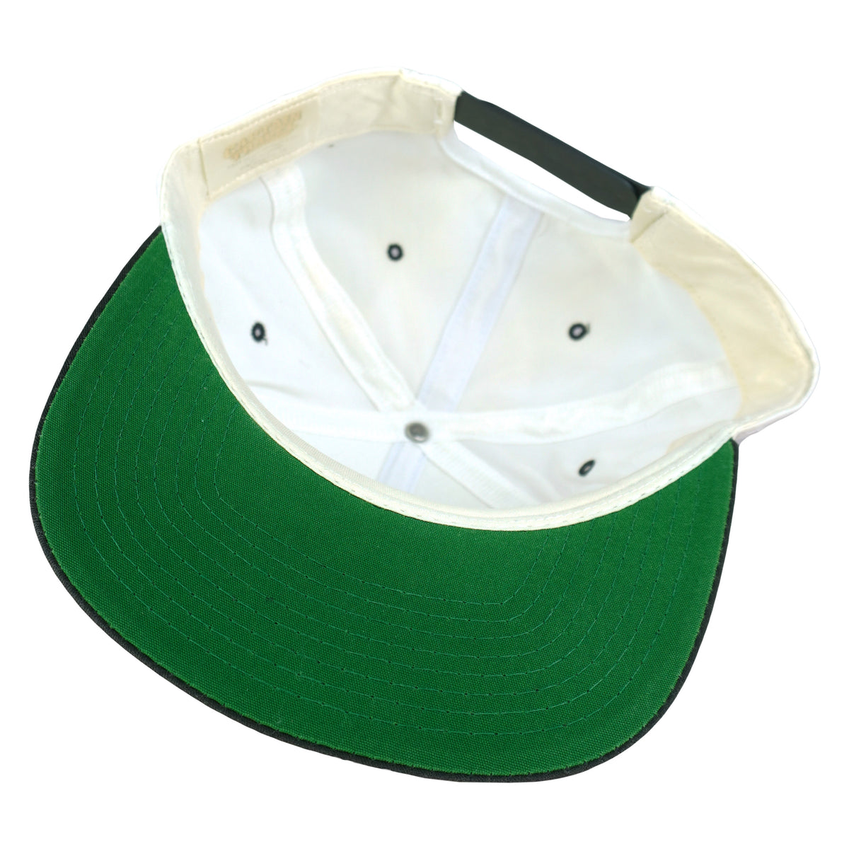 Maker and size label close-up of the white, black, and green The Rock Alcatraz scenic snapback hat