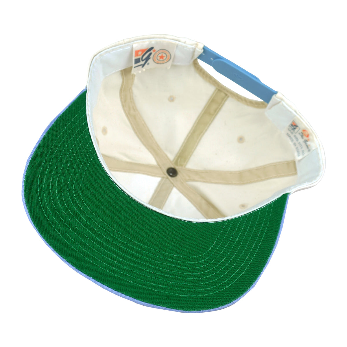 Interior view of the UCLA Bruins hat showing green underbrim and The Game labels