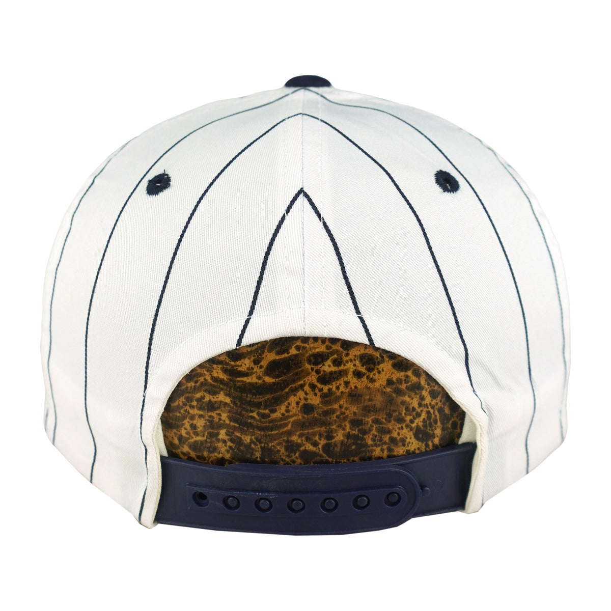 Rear of the white New York Yankees cap with navy stripes, navy eyelets, and a dark plastic snap