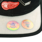 Underside view of the Detroit Red Wings hat with silver brim, team embroidery, and Stanley Cup stickers