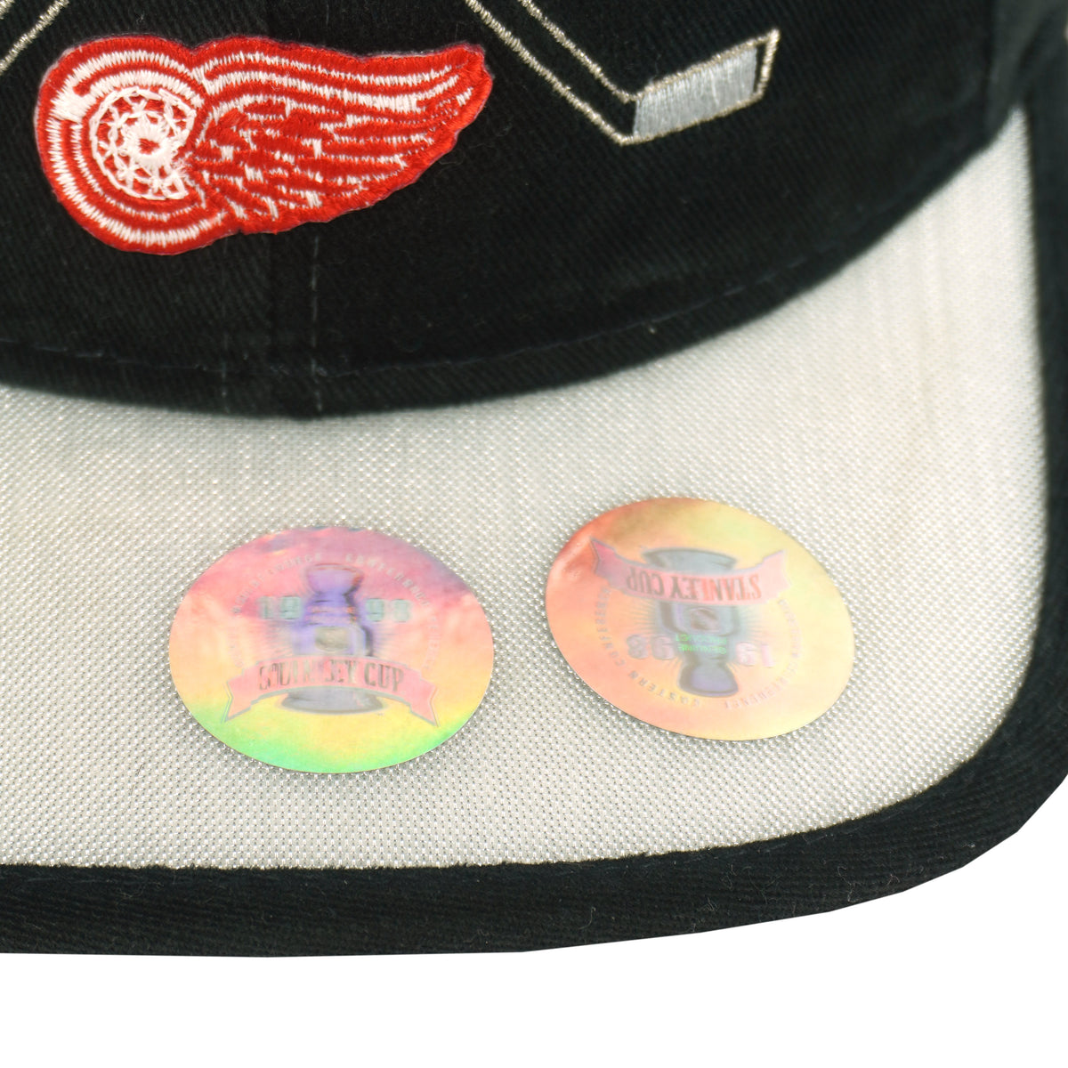 Underside view of the Detroit Red Wings hat with silver brim, team embroidery, and Stanley Cup stickers