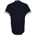 Plain back of the navy Astros T-shirt with gray fabric visible at rolled sleeves