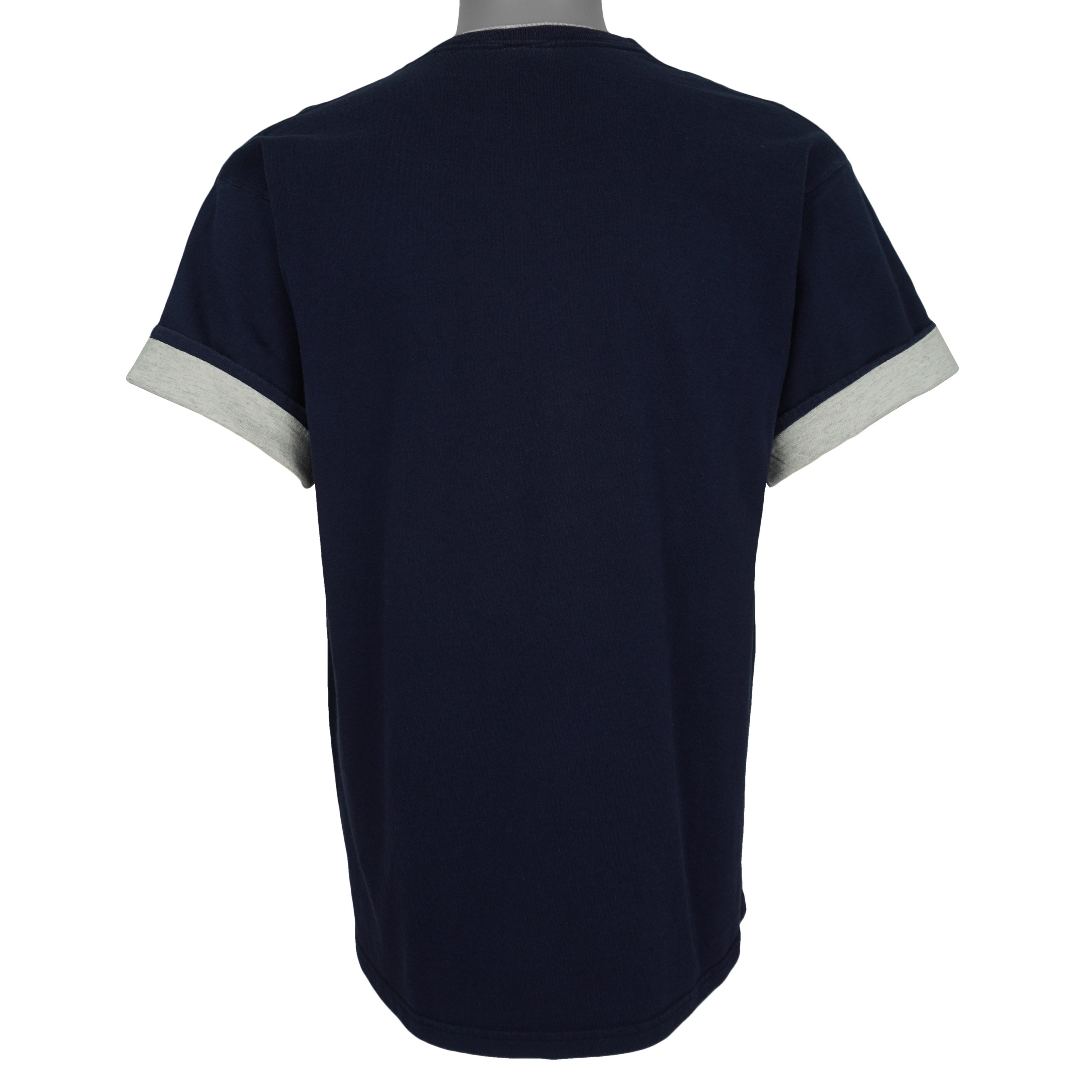 Plain back of the navy Astros T-shirt with gray fabric visible at rolled sleeves