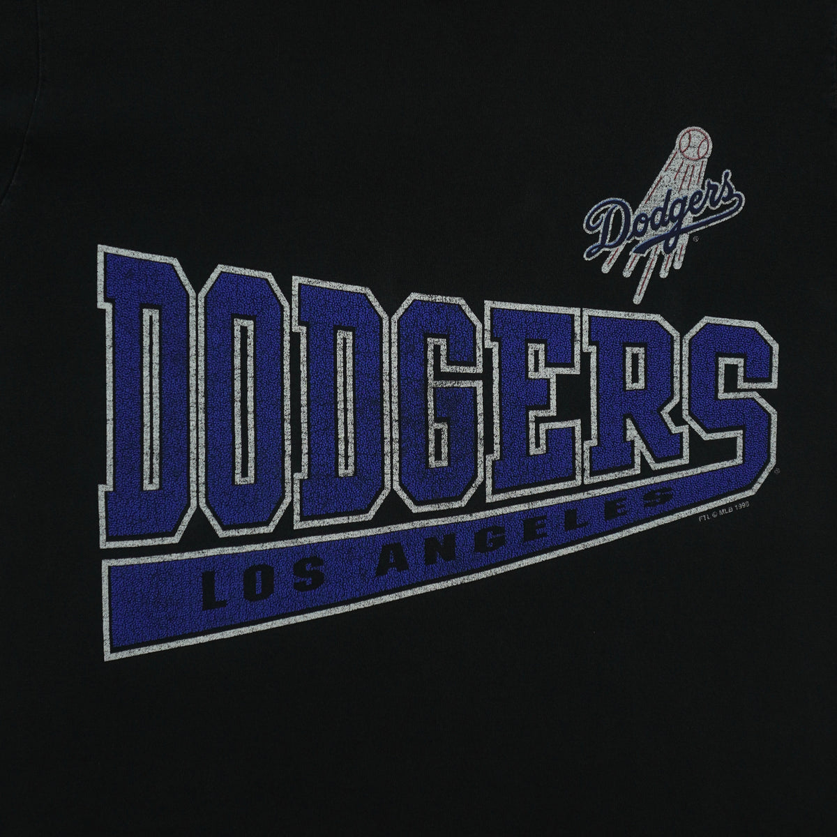 Large blue Dodgers lettering and small script logo on the black T-shirt