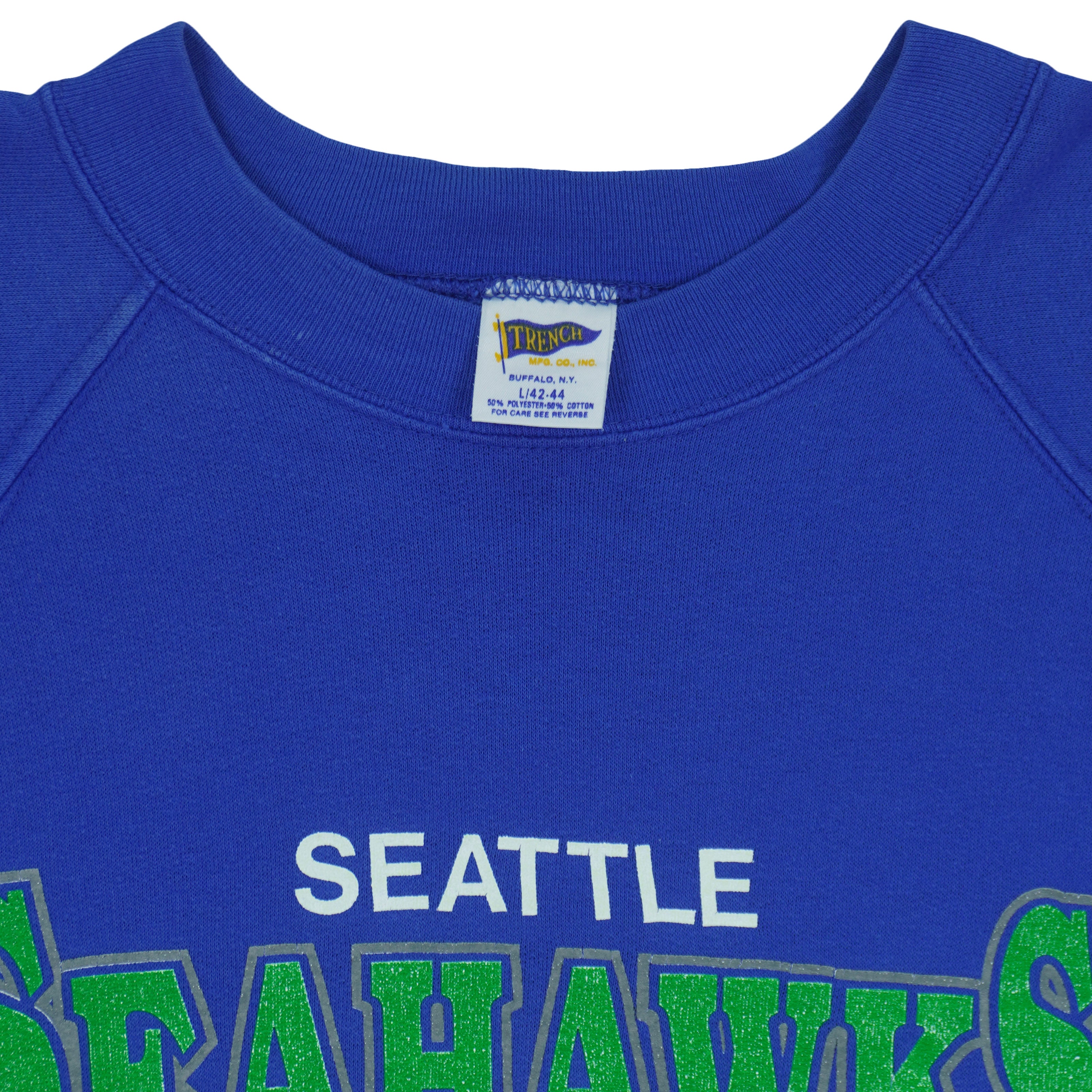 Close view of the Trench Manufacturing label inside the royal blue Seattle Seahawks 1988 AFC West Champions sweatshirt