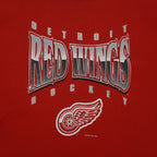 Close view of print and collar detail on the red Detroit Red Wings Logo sweatshirt