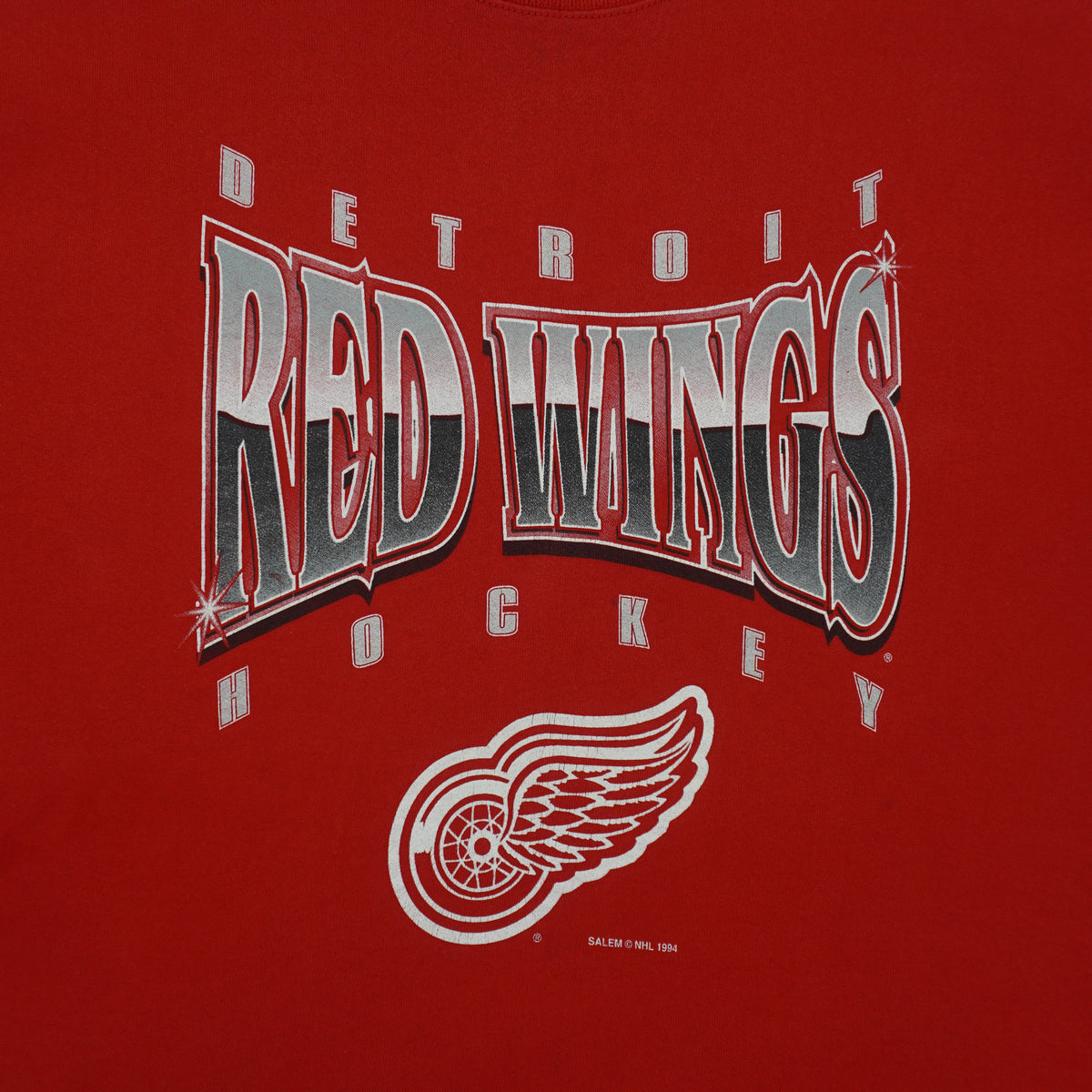 Close view of print and collar detail on the red Detroit Red Wings Logo sweatshirt
