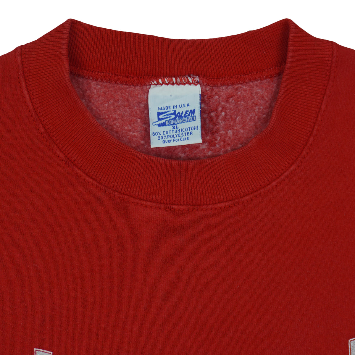 Close view of the Salem Sportswear label inside the red Detroit Red Wings Logo sweatshirt