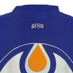 Rear neck brand patch detail of the blue Edmonton Oilers double-sided graphic T-shirt
