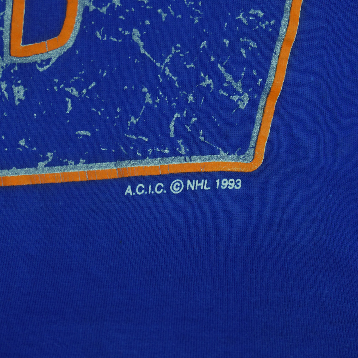 Screen cracking and NHL copyright detail of the blue Edmonton Oilers double-sided graphic T-shirt