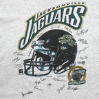 Close-up of the Jacksonville Jaguars helmet graphic, inaugural season logo, and player signatures