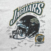 Close-up of the Jacksonville Jaguars helmet graphic, inaugural season logo, and player signatures