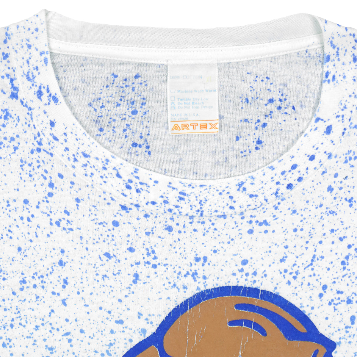 Close-up of the white BYU T-shirt neckline with blue speckled print and a white maker label