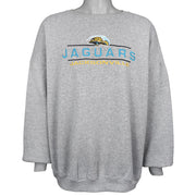 Gray Jaguars sweatshirt front showing the embroidered lettering and ribbed cuffs