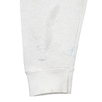 White Tennessee sweatshirt sleeve with blue marks and gray stains near the ribbed cuff