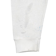 White Tennessee sweatshirt sleeve with blue marks and gray stains near the ribbed cuff