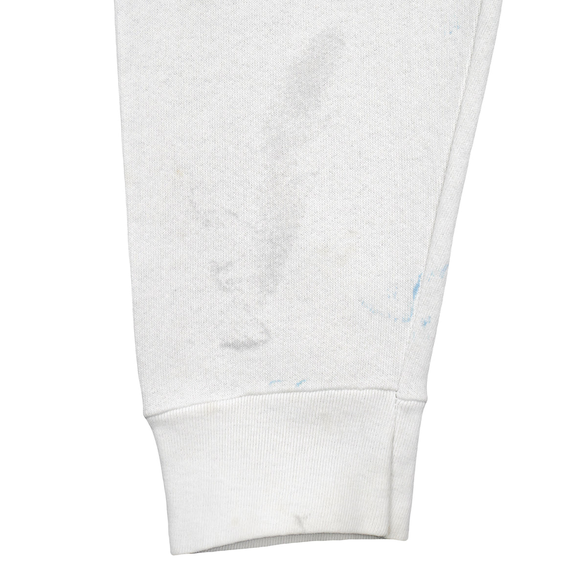 White Tennessee sweatshirt sleeve with blue marks and gray stains near the ribbed cuff