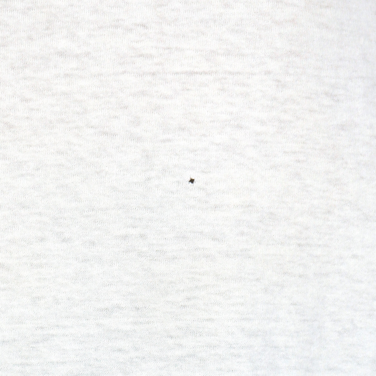 Close view of small back spot on the white One Planet One People globe short sleeve graphic T-shirt