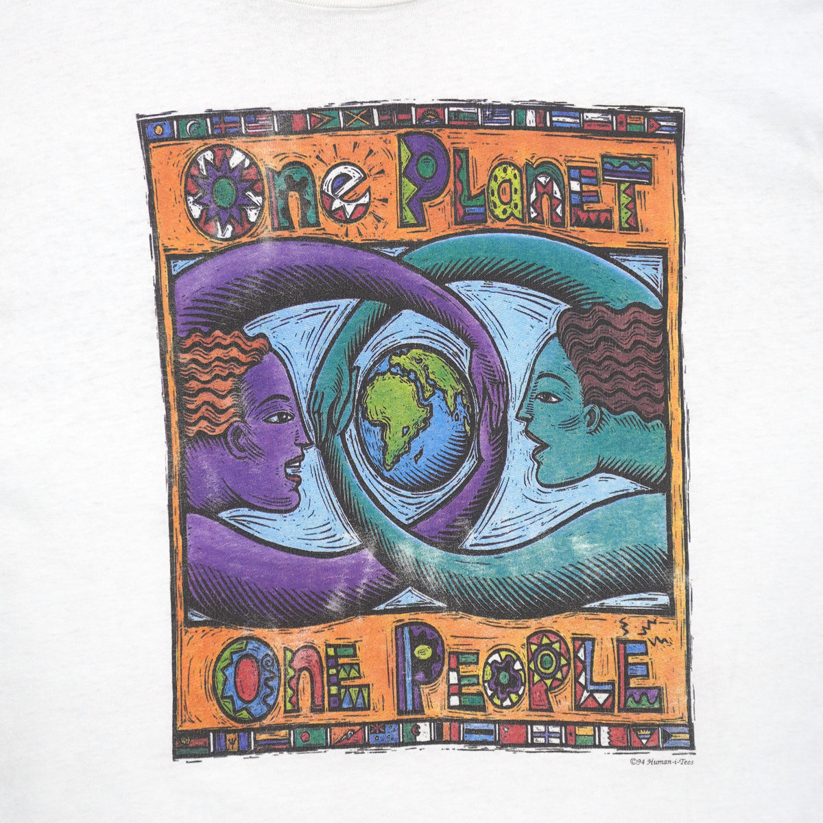 Close view of globe and faces graphic on the white One Planet One People globe short sleeve graphic T-shirt