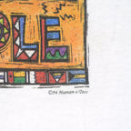 White One Planet T-shirt copyright detail with 1994 text under the colorful graphic