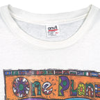 Close view of Anvil size label on the white One Planet One People globe short sleeve graphic T-shirt