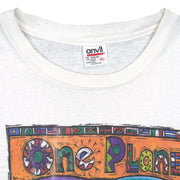 Close view of Anvil size label on the white One Planet One People globe short sleeve graphic T-shirt