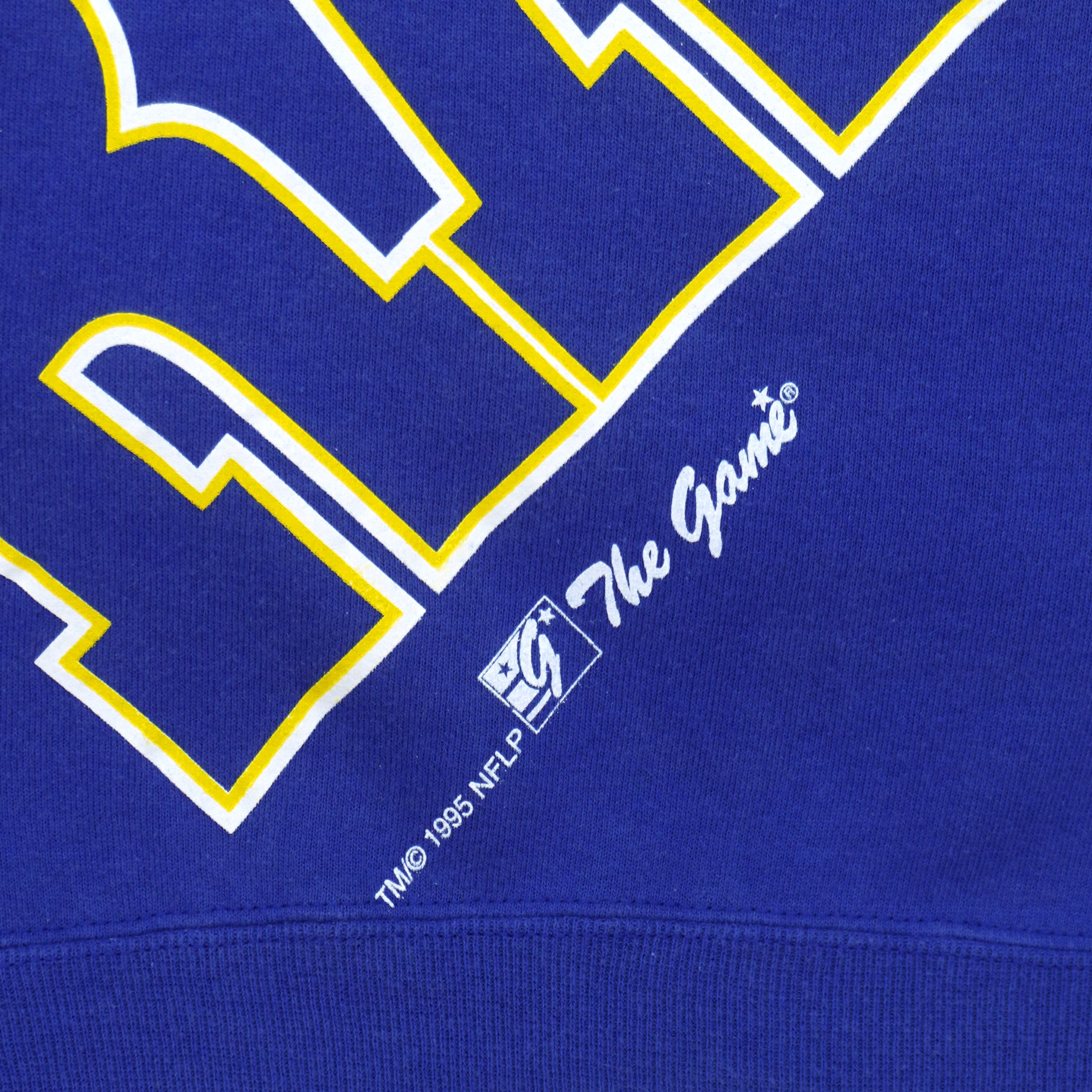 Los Angeles Rams sweatshirt hem with The Game logo and 1995 copyright on blue fabric
