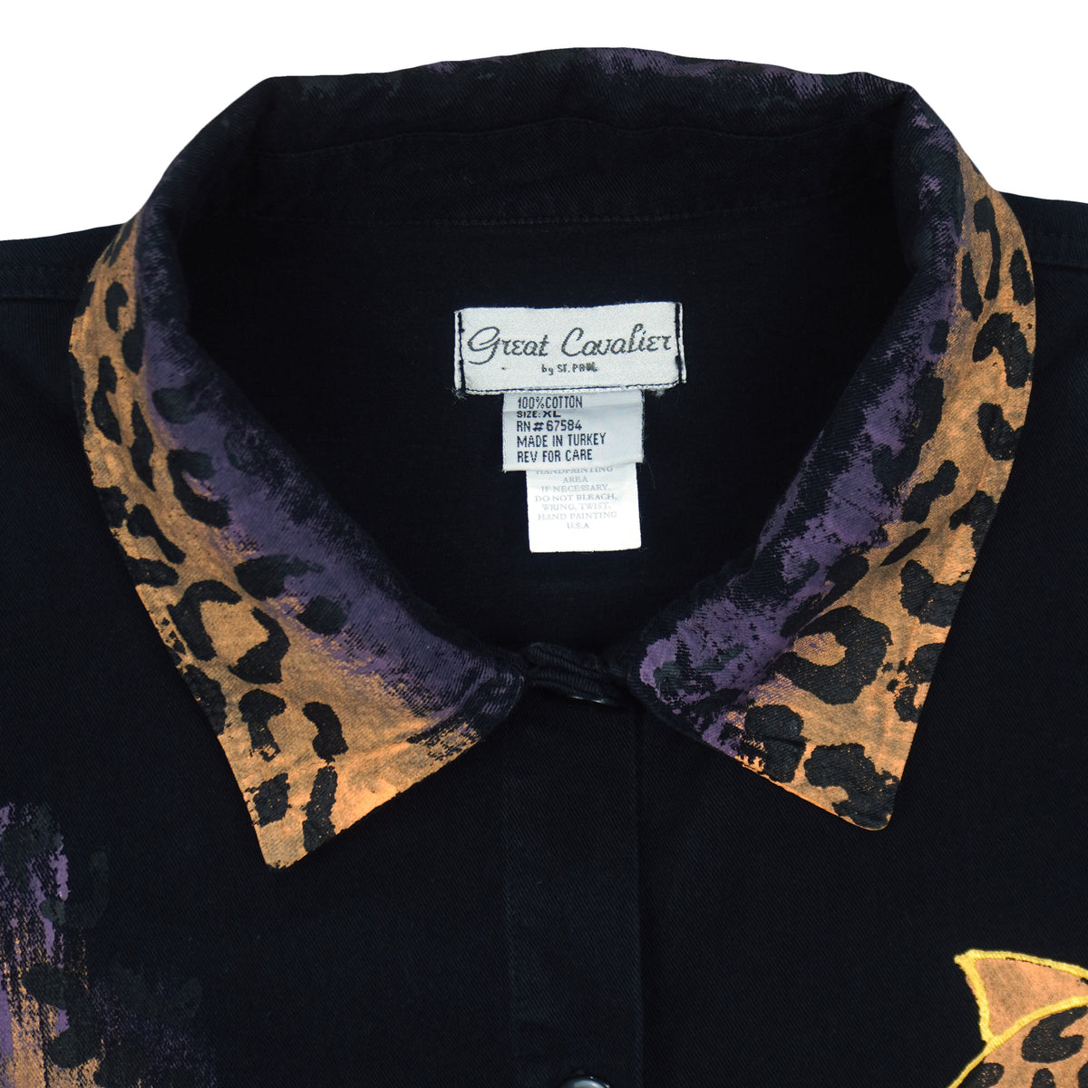 Size and care label on the black leopard graphic button-up shirt