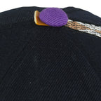 Close-up of the broken purple top button cover on the Diamondbacks cap
