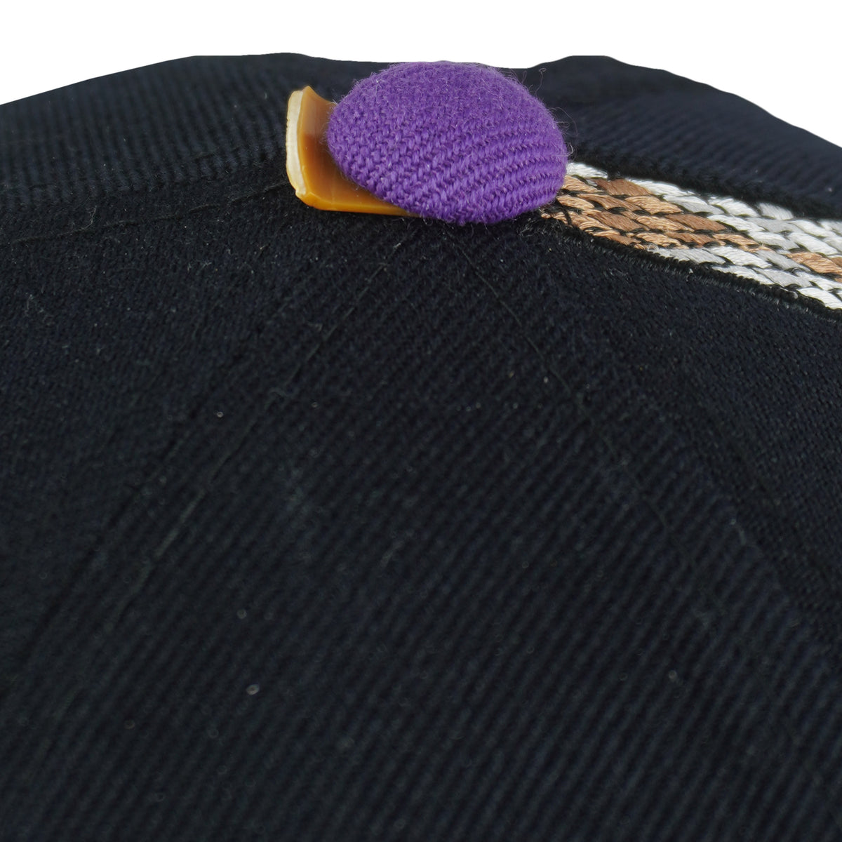 Close-up of the broken purple top button cover on the Diamondbacks cap