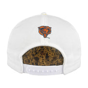 Rear of the white Chicago Bears cap with embroidered bear mascot and snap closure