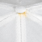 Close-up of yellowing around the top button on the white Bears cap