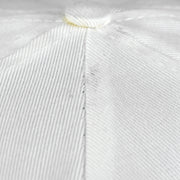 Close-up of the white Bears cap crown seam and woven fabric surface