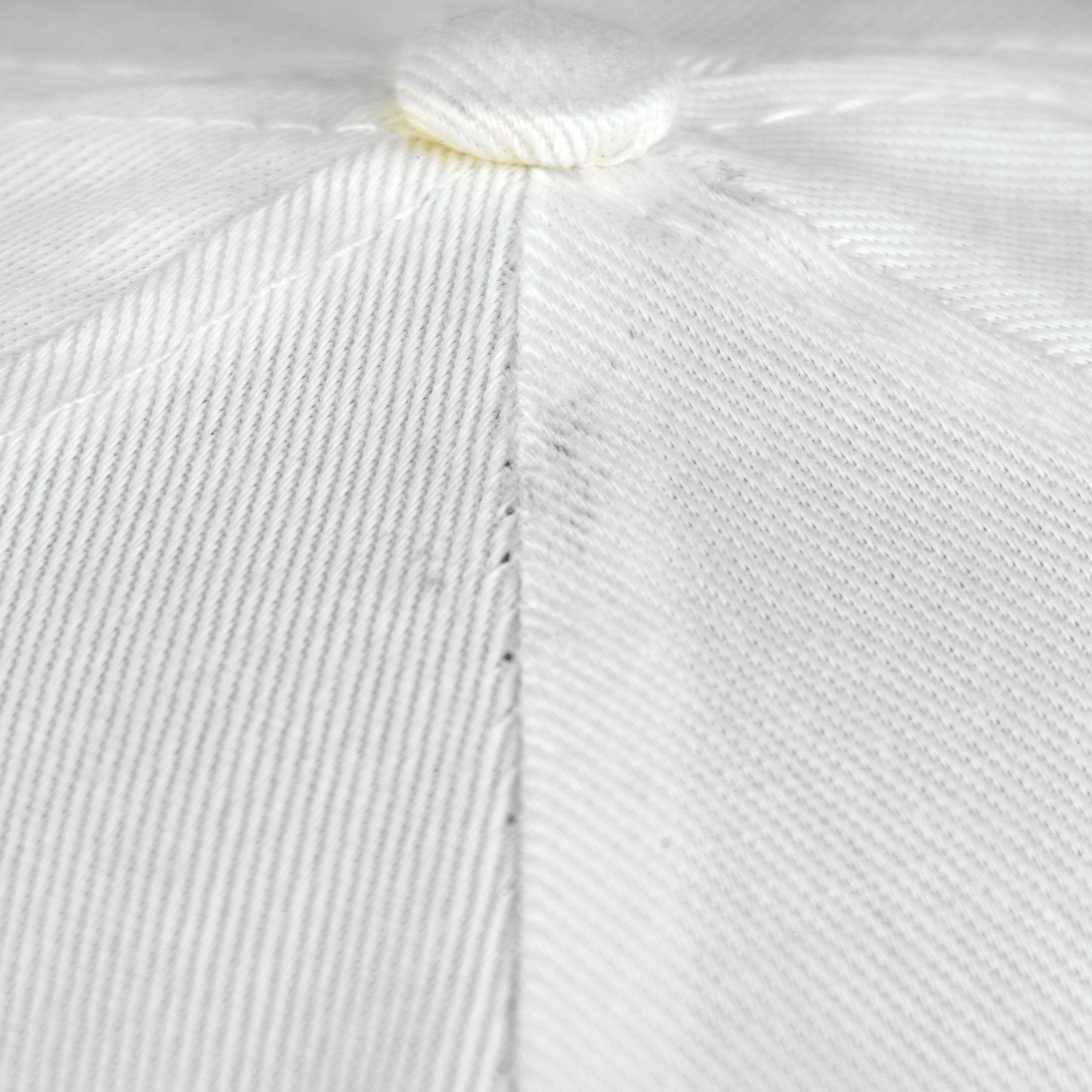 Close-up of the white Bears cap crown seam and woven fabric surface