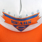 Close view of Chicago Bears lettering and the orange C logo on the white cap front